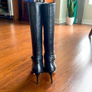 Black Coach knee high boots.